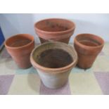 A large terracotta pot along with three others- largest height 45cm