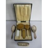 A cased Art Deco dressing table set along with 3 hallmarked silver brushes