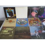 A collection of 12" vinyl records including Black Sabbath, The Beatles, Neil Young, Eric Clapton,