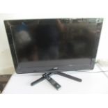 A JVC flatscreen 32 inch TV- remote in office