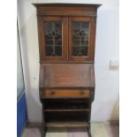 An oak bureau bookcase with stained glass panels