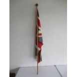 A vintage union flag on wooden pole