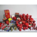 A collection of post office memorabilia including various tins, money banks, salt and pepper