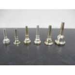 A collection of six mouthpieces including Yamaha, Denis Wick, Vincent Bach Corp, etc.