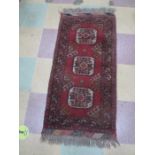 A small hand woven Eastern red ground rug