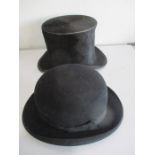 A vintage top hat along with a bowler hat