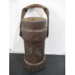 An antique leather gunpowder carrier/bucket with crest to front