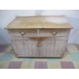 A reclaimed pine dresser base with two drawers and two cupboards under