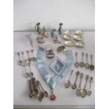 A collection of silver plated items including lighter, candle snuffer, coffee spoons etc.