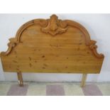 A pine double headboard with carved decoration