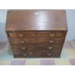 A Georgian oak bureau with four graduated drawers