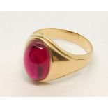 A 14ct gold gentlemans' ring set with a large ruby coloured cabochon stone size T1/2