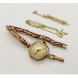 A Victorian rose gold wristwatch on a 9ct strap A/F along with two scrap 9ct chains