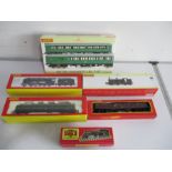 A collection of boxed OO Gauge Hornby railway locomotives and carriages including a class 9F