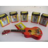 A collection of Simpsons memorabilia including bottle openers, ukulele etc.