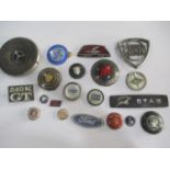 A small collection of vintage car badges including Ford, BMW, Jaguar, Vauxhall etc