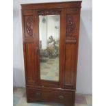 An Edwardian wardrobe with mirrored door