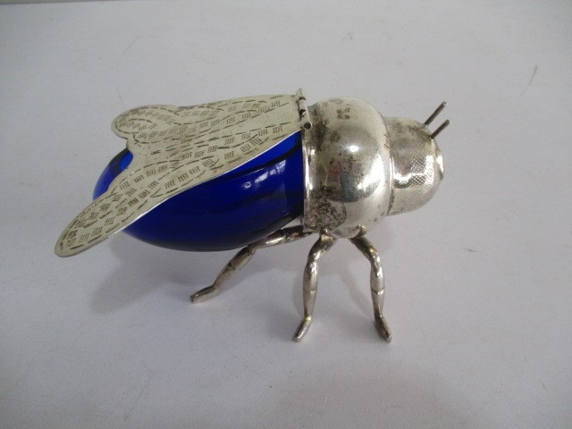 A silver plated and blue glass sugar bowl in the form of a fly, hinged wings as the cover