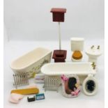 A collection of bathroom related dolls house items to include bath, sink, mirrors and accessories