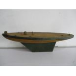 A vintage wooden model yacht hull with metal keel