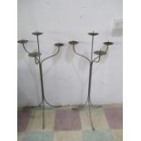 A pair of wrought iron two branch candelabra, height 100cm
