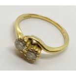 A diamond crossover ring set in 18ct gold - each diamond approx 0.3ct