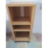 A beech effect mobile shelving unit