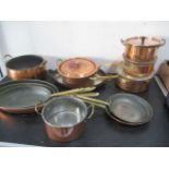 A collection of copper saucepans and frying pans etc.