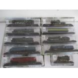 A collection of ten various model locomotives on tracks.