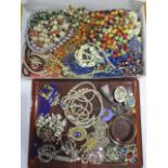 Two trays of costume jewellery including amber coloured beads