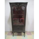 A turn of the century display cabinet with cupboard under, red velvet lining to back and shelves.