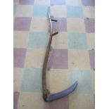 An antique wooden handled scythe