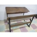 A vintage double school desk with folding bench both with iron frames