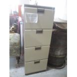 A filing cabinet with four drawers and key