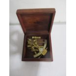 A reproduction brass sextant in wooden box