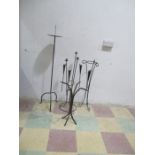 Two wrought iron candelabra's along with a wrought iron single candle holder and plant stand.