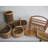 A collection of wicker baskets, along with a wicker umbrella pot and magazine rack