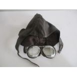 A vintage leather motorcycle hat, along with Halcyon motorcycle goggles