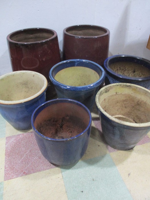 Seven glazed garden pots- tallest 50cm