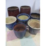 Seven glazed garden pots- tallest 50cm