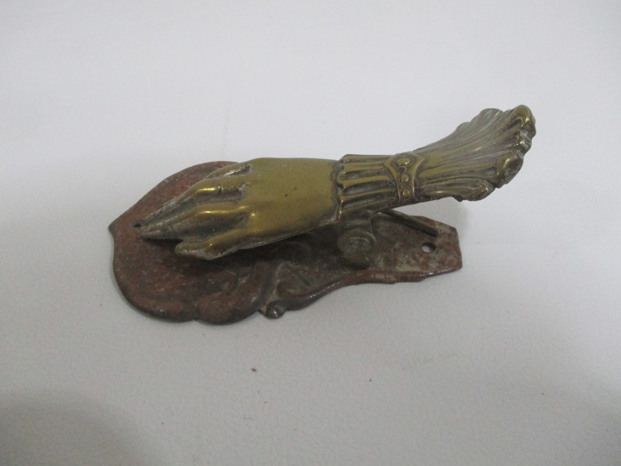 A novelty brass letter clip in the form of a hand