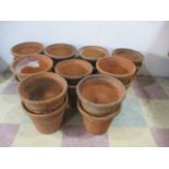 A collection of 18 terracotta flower pots, all approx 24cm height
