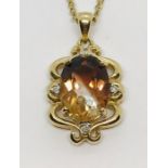 A smoky topaz and diamond pendant set in 9ct gold on a 9ct gold chain