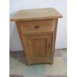 A pine bedside cabinet