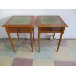 A pair of reproduction bedside cabinets with leather tops
