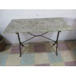 A marble topped garden table with cast iron legs