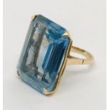 A 9ct gold ring set with a large blue topaz stone