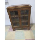 An freestanding oak display cabinet