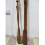 A pair of wooden oars along with two others