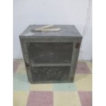 A vintage meat safe with tongs